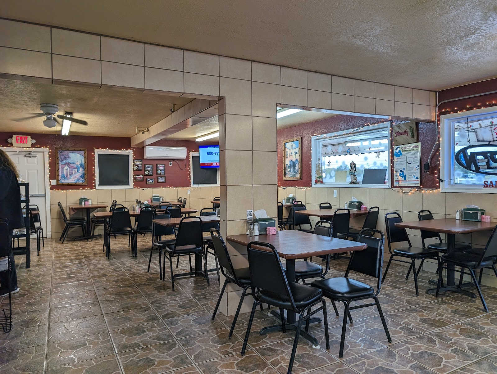 Warm dining room at Family Mexican Restaurant with string lights and framed pictures